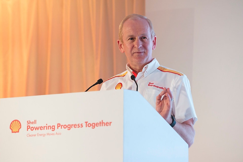 Shell’s Downstream Director John Abbott standing on a podium and speaking over the mic