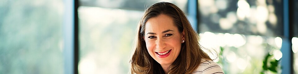 Lucia Lombardo smiling at camera in the office